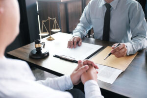 client talking to lawyer across the desk