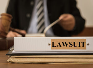 lawyer sitting with lawsuit binder