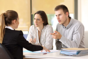 couple talking to lawyer about filing suit