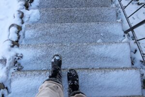 person approaching snowy steps in Philadelphia