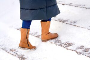 woman walking on snowy steps in Philadelphia